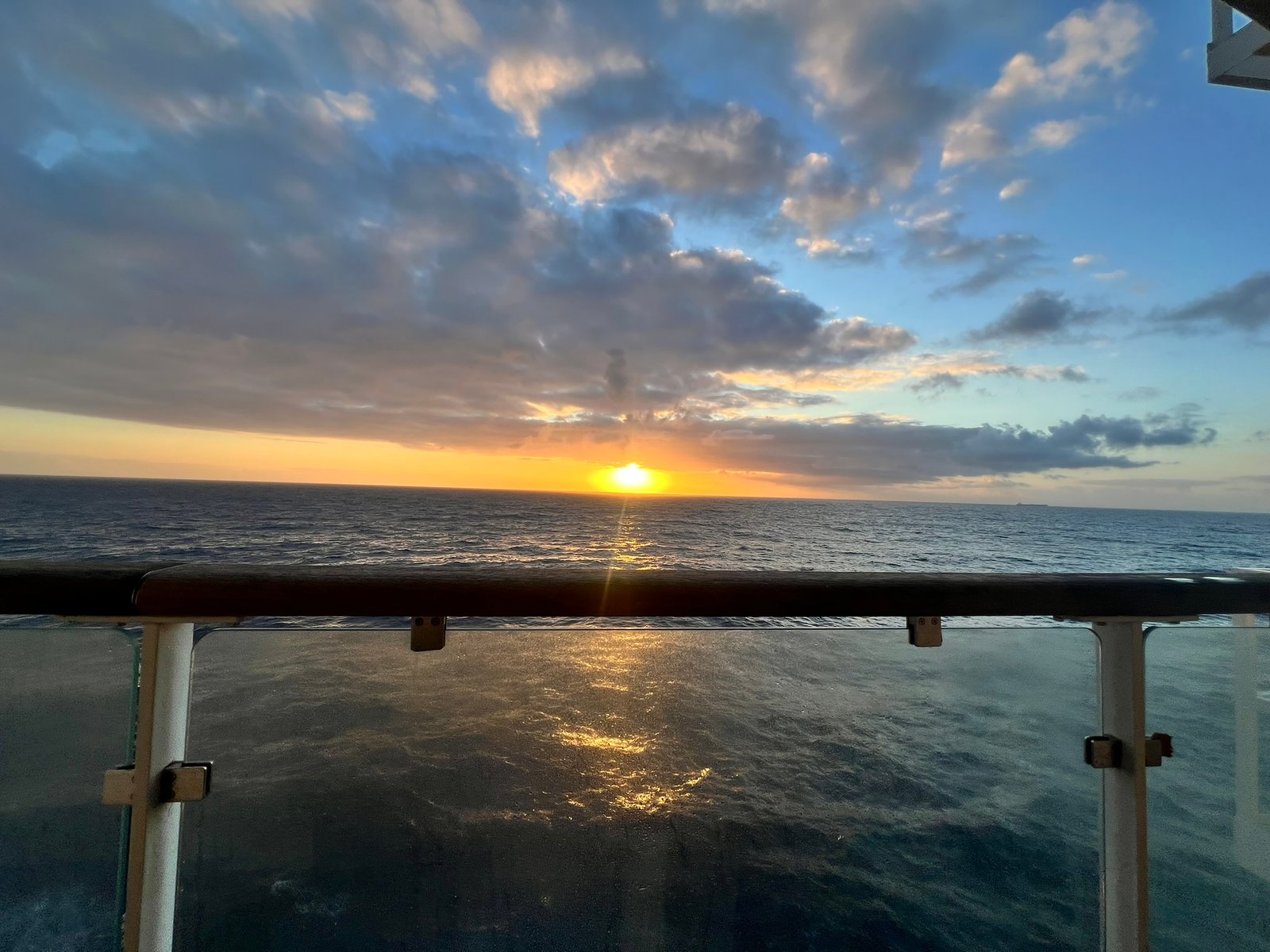 Sunset over open water seen from the deck of a ferry to Spain